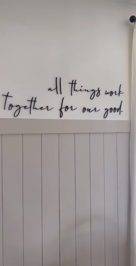 Personalized wood quote above shiplap wall.