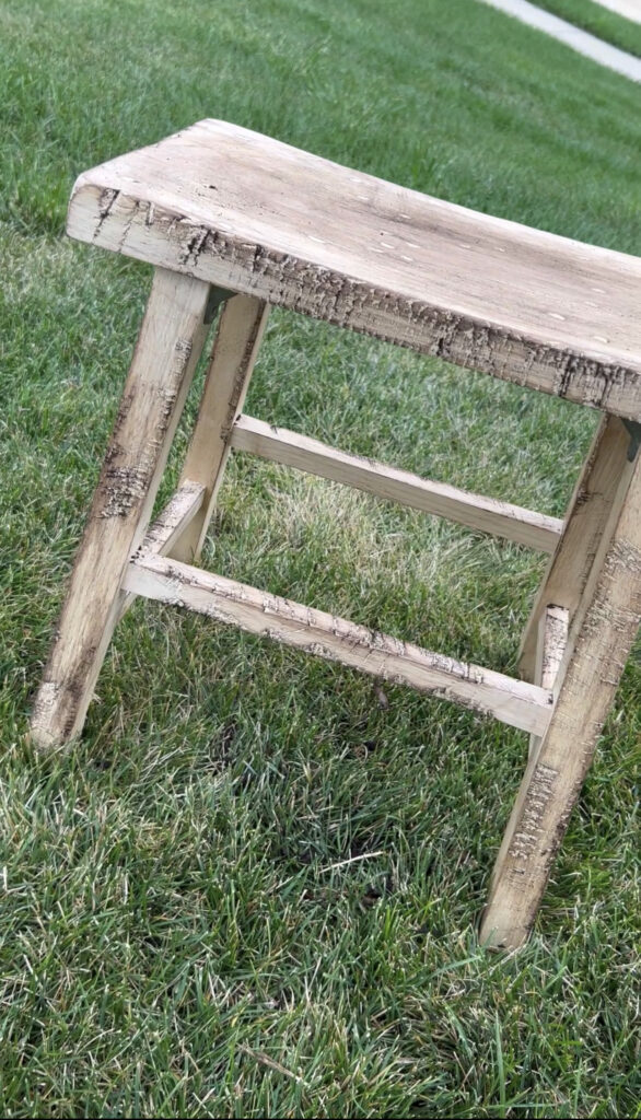 The stool with dirt rubbed into the nicks and cuts.